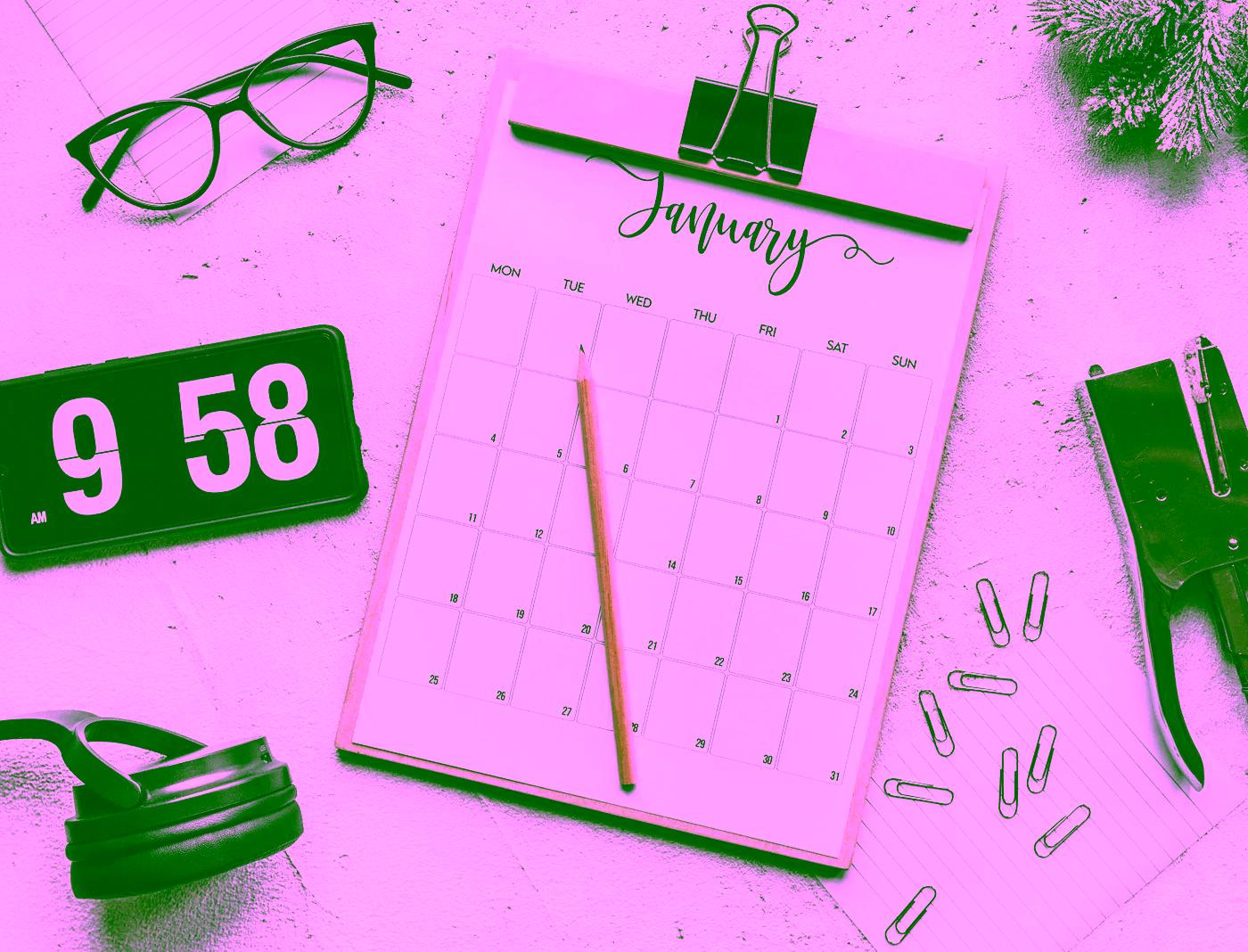 A calendar, glasses and stationery arranged on a desk