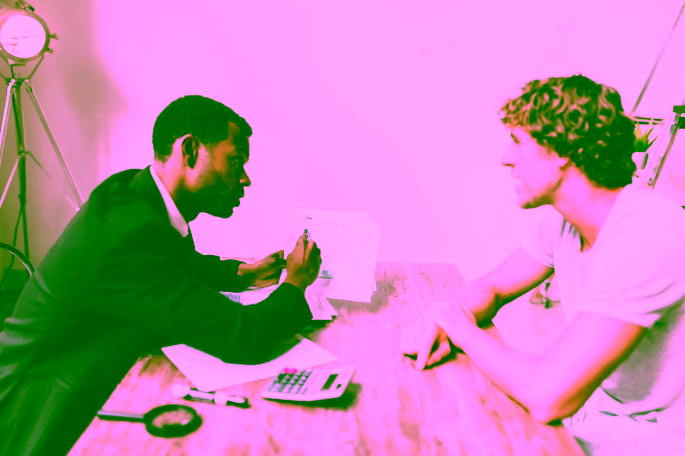 A professional reviewing paperwork with another person
